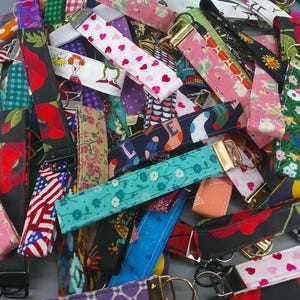 May include: A set of three ceramic mugs with a speckled, matte finish. The mugs are in shades of cream, light gray, and dark gray. Each mug has a simple, minimalist design and a rounded handle. The mugs are stacked on top of each other.