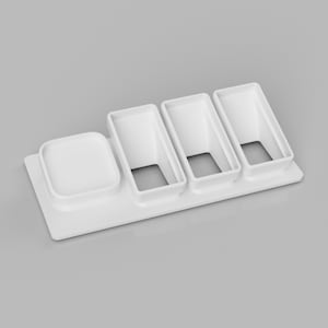 May include: White plastic organiser with four compartments. The organiser has a square compartment and three rectangular compartments.