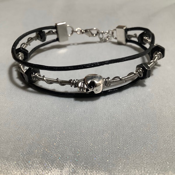 Wire wrapped bass guitar string bracelet with skull and hex nuts