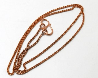 May include: A copper chain necklace with a lobster clasp closure. The chain is made of small, linked circles.