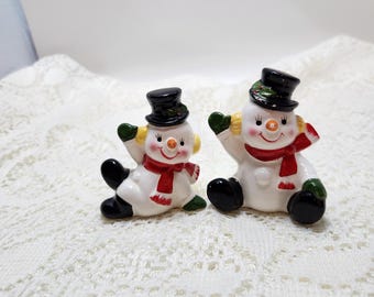 Set of 2 tumbling ceramic snowmen