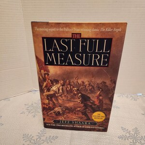 May include: A hardcover book titled "The Last Full Measure" by Jeff Shaara. The cover features a battle scene in shades of brown and tan, with the title in large white letters. The book is a New York Times bestseller.