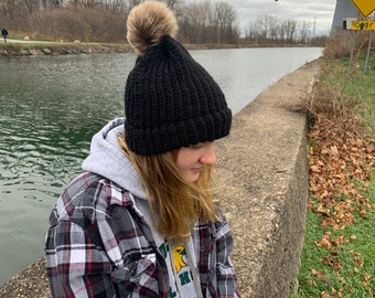 Black hat with tan pom pom