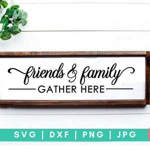 May include: A wooden sign with the text "friends & family gather here" in black script font. The sign is on a white background with a checkered pattern and greenery.