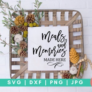 May include: A white sign with black calligraphy that reads "Meals and Memories Made Here" in a rustic wooden crate with fall-themed decor.