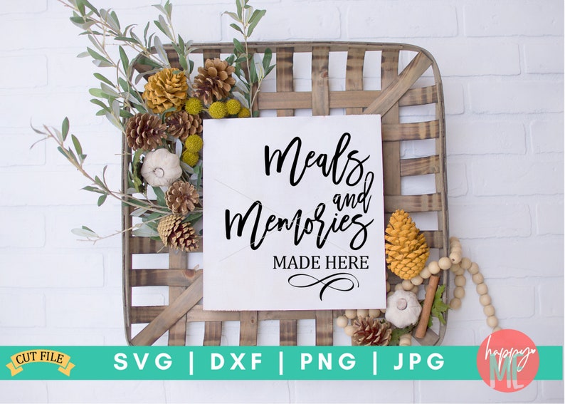 May include: A white sign with black calligraphy that reads "Meals and Memories Made Here" in a rustic wooden crate with fall-themed decor.