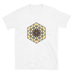 May include: White t-shirt with a geometric design in black, orange, and yellow. The design is a hexagonal pattern with a central black shape.