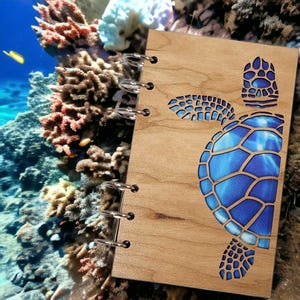 May include: A wooden spiral bound journal with a blue and white sea turtle design cut out of the front cover.