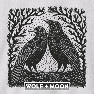 May include: Black and white illustration of two crows perched on a branch with the text "WOLF + MOON" below.