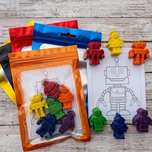 May include: A set of colorful robot-shaped crayons in a clear plastic bag with a robot coloring page. The crayons are red, orange, yellow, green, blue, purple, and black.