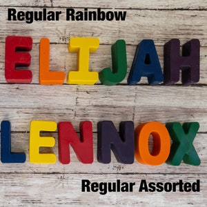May include: Two names spelled out with colorful letter blocks. The name "ELIJAH" is spelled out with rainbow colored blocks. The name "LENNOX" is spelled out with assorted colored blocks. The text "Regular Rainbow" is above the first name and the text "Regular Assorted" is below the second name.
