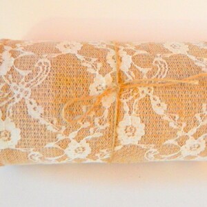 May include: A roll of hessian ribbon with white lace trim. The ribbon is tied with twine.
