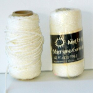 May include: Two spools of white macrame cord, one with a label that reads "Knot Craft Macrame Cords 100 ft. (33 1/2 YDS.) Wellington Polymer Mills Inc. - Made in USA"