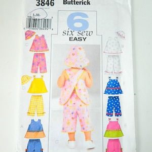 May include: A sewing pattern for six easy-to-sew baby outfits. The pattern includes a variety of styles, including dresses, tops, and pants. The pattern is for sizes L and XL.