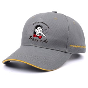 May include: A gray baseball cap with a yellow brim. The front of the cap features a cartoon illustration of a man with a long nose and the text "Dumb Advertisement Stark Plug".