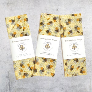 Beeswax wraps and bag sets showing the happy little honeybees on a honeycomb background pattern.