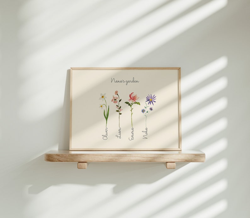 May include: A framed print with the text "Nana's garden" and four illustrated flowers with names below them: Oliver, Liam, Emma, Noah.
