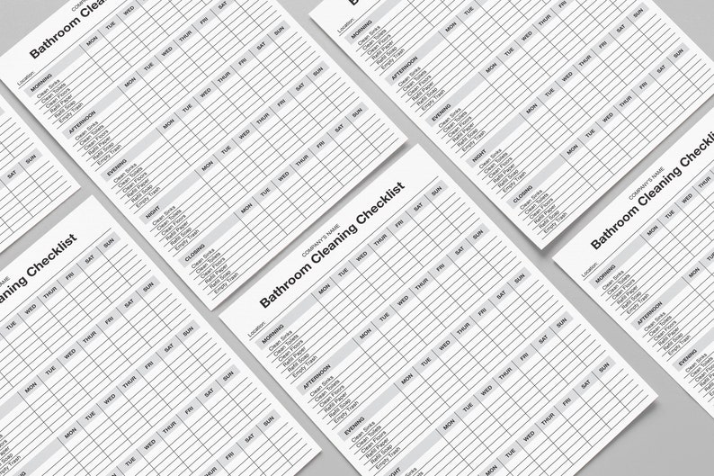 May include: Several white paper checklists titled "Bathroom Cleaning Checklist" are arranged diagonally. Each checklist has a grid layout with columns for days of the week and rows for cleaning tasks, including "Clean Sinks" and "Empty Trash".