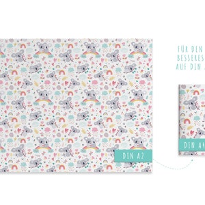 May include: White paper with a repeating pattern of gray koalas, rainbows, clouds, and hearts. The design includes text that reads "DIN A2" and "DIN A4". The overall theme is a cute, whimsical design.