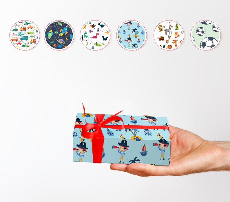 May include: A gift box wrapped in light blue paper with a pirate-themed pattern, tied with a bright red ribbon. The pattern includes cartoon pirates, ships, and palm trees. Six circular designs with various patterns are in the background.