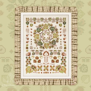 May include: A cross-stitch pattern featuring a circular design of leaves and nuts in shades of brown, green, and cream. The pattern is framed with a brown and white gingham border.