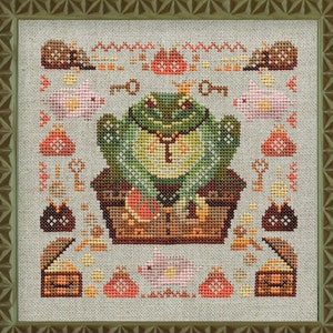 May include: A cross-stitch pattern featuring a green frog sitting on a treasure chest, surrounded by pink pigs, brown hedgehogs, and gold coins. The frog is wearing a crown and a necklace.