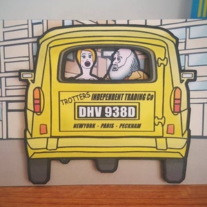 May include: A humorous greeting card featuring a yellow van with the text "Trotters Independent Trading Co" and "DHV 938D". The van has two passengers, and the background shows a city scene. The card also has the text "New York - Paris - Peckham".