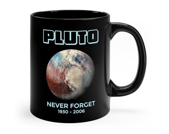 May include: Black ceramic coffee mug with a graphic of Pluto, the text "Pluto" in blue, and the text "Never Forget 1930 - 2006".