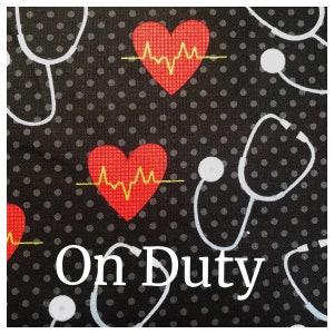 May include: Black fabric with white polka dots and a repeating pattern of red hearts with yellow EKG lines and white stethoscopes. The text "On Duty" is printed in white on the fabric.