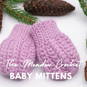 May include: A pair of light purple knitted baby mittens featuring a textured stitch pattern and a central vertical rib detail. The text "The Meadow Crochet BABY MITTENS" is overlaid in white script and bold sans-serif font across the mittens.