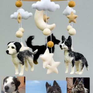 May include: A handcrafted baby mobile with felt dog figures, stars, clouds, and a crescent moon. The mobile is suspended from a wooden ring by white strings. The bottom of the image shows three photos of dogs.