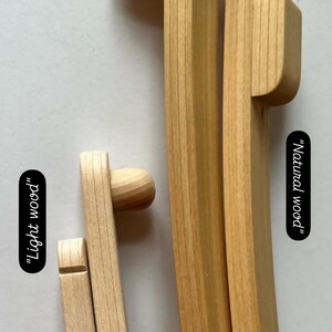 May include: Two wooden embroidery hoops, one with a natural wood finish and the other with a lighter wood finish. The hoops are labeled "Natural wood" and "Light wood".
