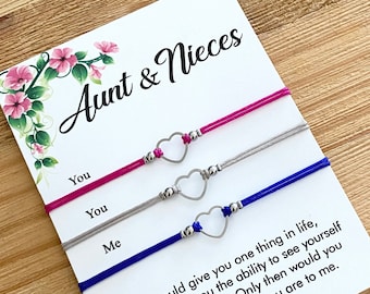 May include: Three friendship bracelets with heart charms and the text "Aunt & Nieces" on a white card. The bracelets are pink, gray, and blue. The text on the card reads: "If I could give you one thing in life, I would give you the ability to see yourself through my eyes. Only then would you realize how special you are to me. anjordcraft.etsy.com"