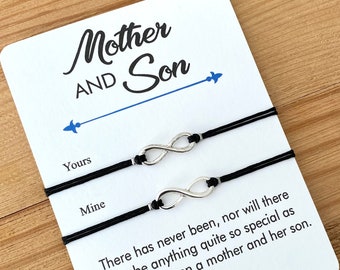 May include: Two black string bracelets with silver infinity symbols. The bracelets are on a white card with the text "Mother and Son" and "There has never been, nor will there ever be anything quite so special as the love between a mother and her son."