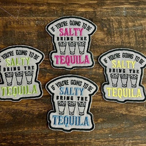 May include: Four gray embroidered iron-on patches with the text "If you're going to be salty bring the tequila" and a row of three shot glasses. The patches have different colored text and shot glasses.