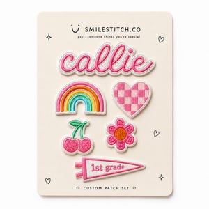 May include: A set of six embroidered patches on a display card labeled SMILESTITCH.CO. The patches include the name callie in pink, a rainbow, a pink checkered heart, two cherries, a pink flower, and a white pennant flag with 1st grade text.