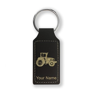 May include: Black leather keychain with a gold tractor silhouette and the text "Your Name".