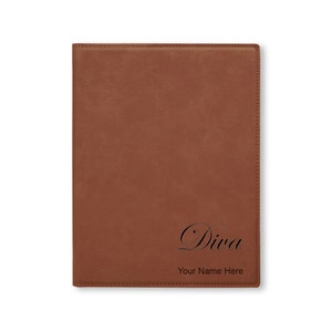 May include: A brown leather-bound journal with the word "Diva" and the text "Your Name Here" engraved on the front cover.