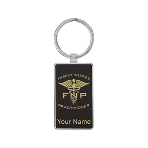 May include: Black leather keychain with a gold medical symbol and the text "Family Nurse FNP Practitioner". The keychain also has a silver ring and the text "Your Name".