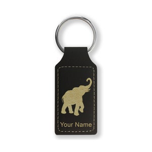 May include: Black leather keychain with a gold elephant silhouette and the text "Your Name".