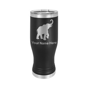 May include: Black stainless steel tumbler with a silver lid. The tumbler has a white silhouette of an elephant with its trunk raised. The text "Your Name Here" is engraved below the elephant.
