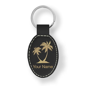 May include: Black leather oval keychain with a gold palm tree design and the text "Your Name".