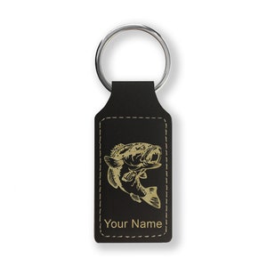 May include: Black leather keychain with a gold-colored bass fish design and the text "Your Name".