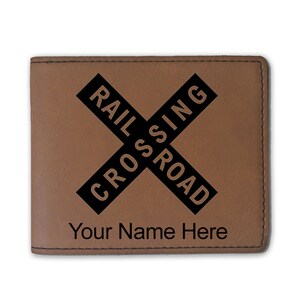 May include: Brown leather wallet with a black railroad crossing sign and the text "Your Name Here".