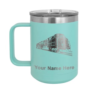May include: A teal stainless steel travel mug with a black and white silhouette of a train and the text "Your Name Here".