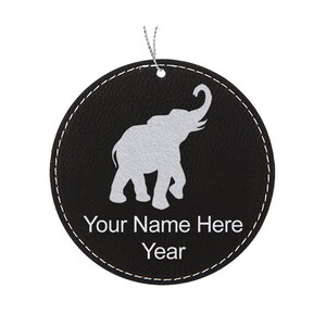 May include: Black leather round ornament with a white elephant silhouette and the text "Your Name Here Year".