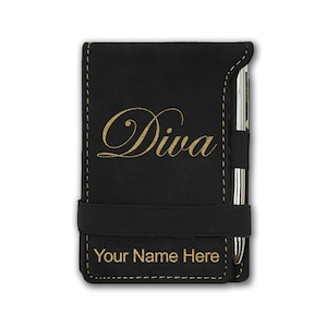 May include: Black faux leather notebook with a gold inscription that reads "Diva" and a black elastic band. The notebook has a pen holder and a gold inscription that reads "Your Name Here".