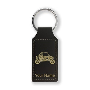 May include: Black leather keychain with a gold outline of an off-road vehicle and the text "Your Name".