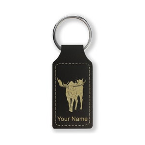 May include: Black leather keychain with a gold moose silhouette and the text "Your Name" engraved on it.