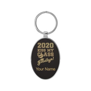 May include: Black oval keychain with a silver metal ring. The keychain has gold text that reads "2020 Kiss My Class Goodbye!" with a graduation cap and lips graphic. The text "Your Name" is at the bottom.